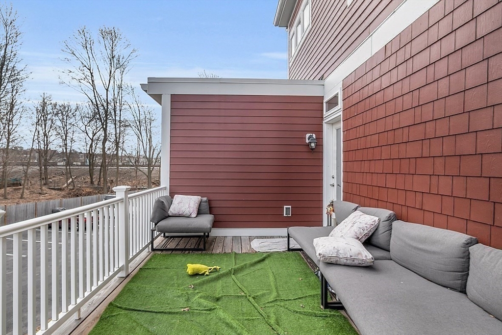 3 Elm Street, Unit 4 Boston, MA 02122 - Photo 16 of 24 a balcony with furniture and a potted plant