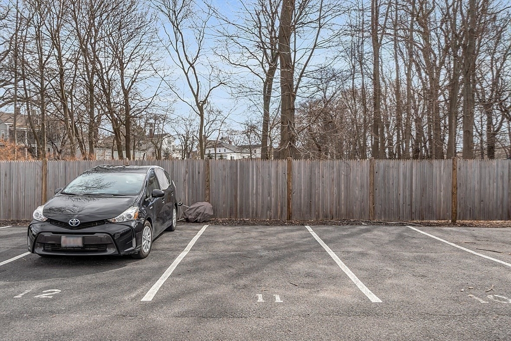 3 Elm Street, Unit 4 Boston, MA 02122 - Photo 20 of 24 a front view of a house with a garden and parking space