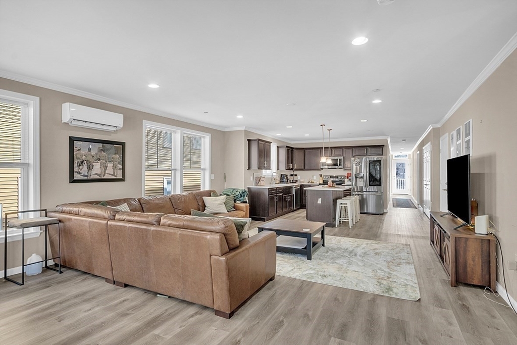 3 Elm Street, Unit 4 Boston, MA 02122 - Photo 2 of 24 a living room with furniture and a flat screen tv