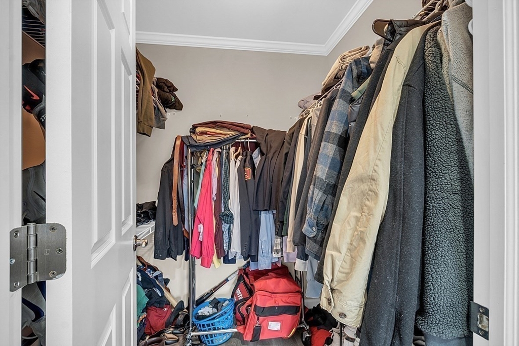 3 Elm Street, Unit 4 Boston, MA 02122 - Photo 22 of 24 a view of walk in closet with clothes and shoes