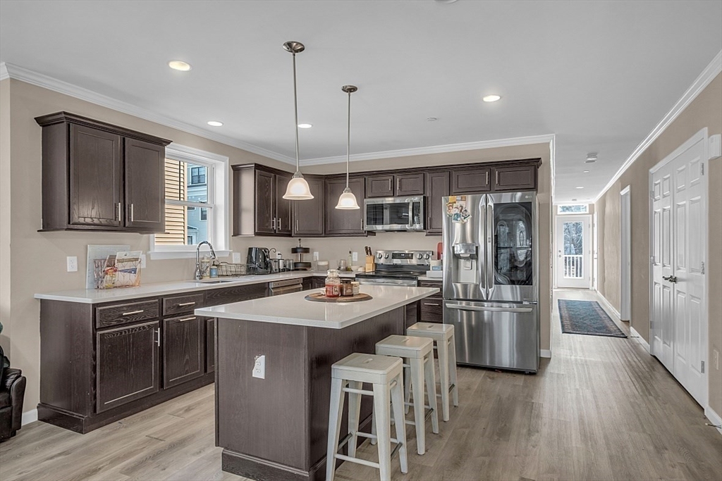 3 Elm Street, Unit 4 Boston, MA 02122 - Photo 3 of 24 a kitchen with stainless steel appliances granite countertop a sink stove and refrigerator