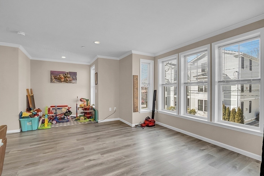 3 Elm Street, Unit 4 Boston, MA 02122 - Photo 5 of 24 a view of a room with wooden floor and gym equipment