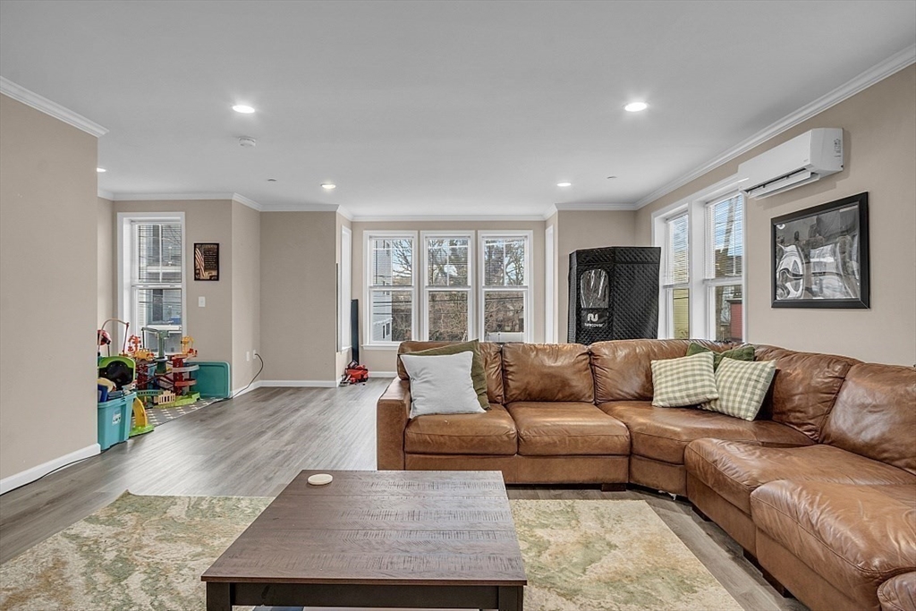 3 Elm Street, Unit 4 Boston, MA 02122 - Photo 6 of 24 a living room with furniture and a flat screen tv