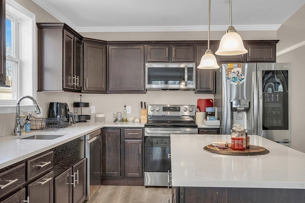 3 Elm Street, Unit 4 Boston, MA 02122 - Photo 7 of 24 a kitchen with stainless steel appliances granite countertop a sink and a stove