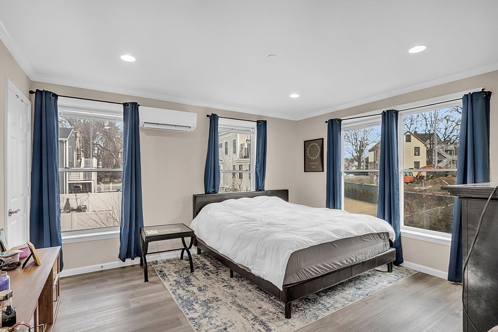 3 Elm Street, Unit 4 Boston, MA 02122 - Photo 10 of 24 a bedroom with a large bed and a window
