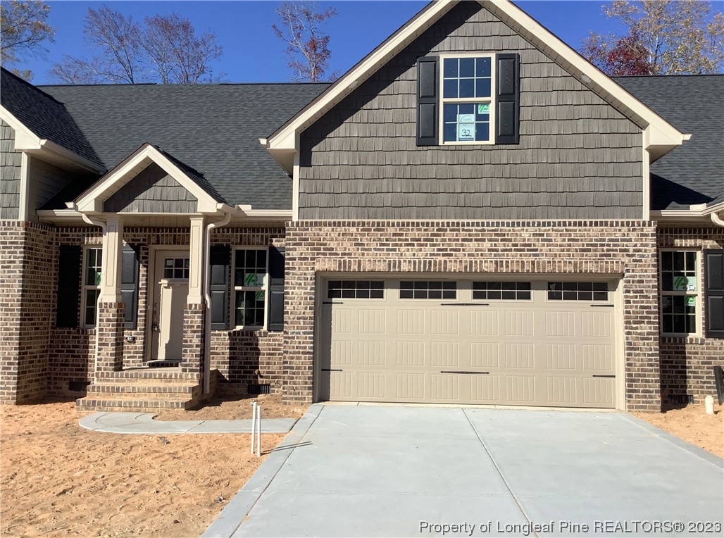 152 Lark Drive Pinehurst, NC 27376 - Photo 2 of 2 a front view of a house with a yard in front of it