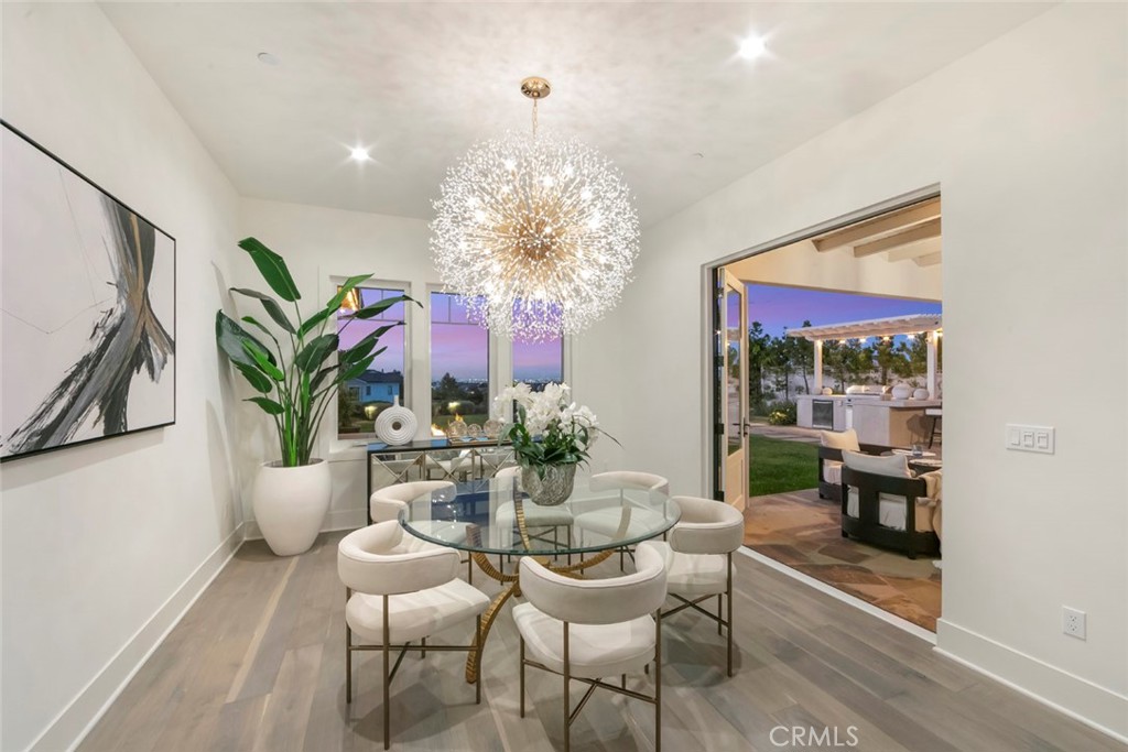 5 Rancho Elastico Road Rolling Hills Estates, CA 90274 - Photo 42 of 48 a dining room with furniture a chandelier and wooden floor