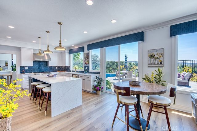 a large kitchen with kitchen island a sink stainless steel appliances and cabinets