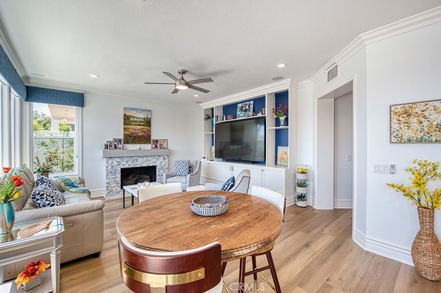 a living room with fireplace furniture and a large window