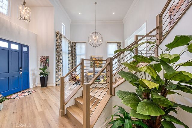 a bedroom with a bed and large windows