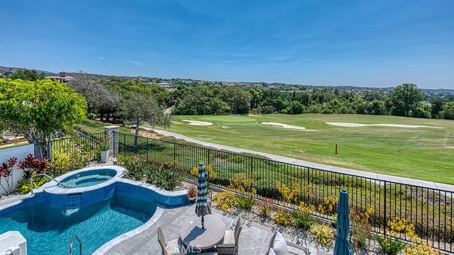 a living room with furniture chandelier and a wooden floor