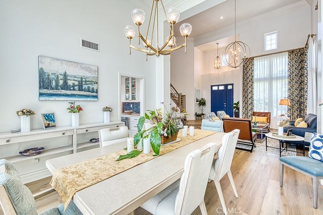 a living room with furniture kitchen view and a large window