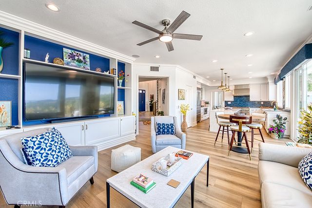 a kitchen with a table chairs and white cabinets