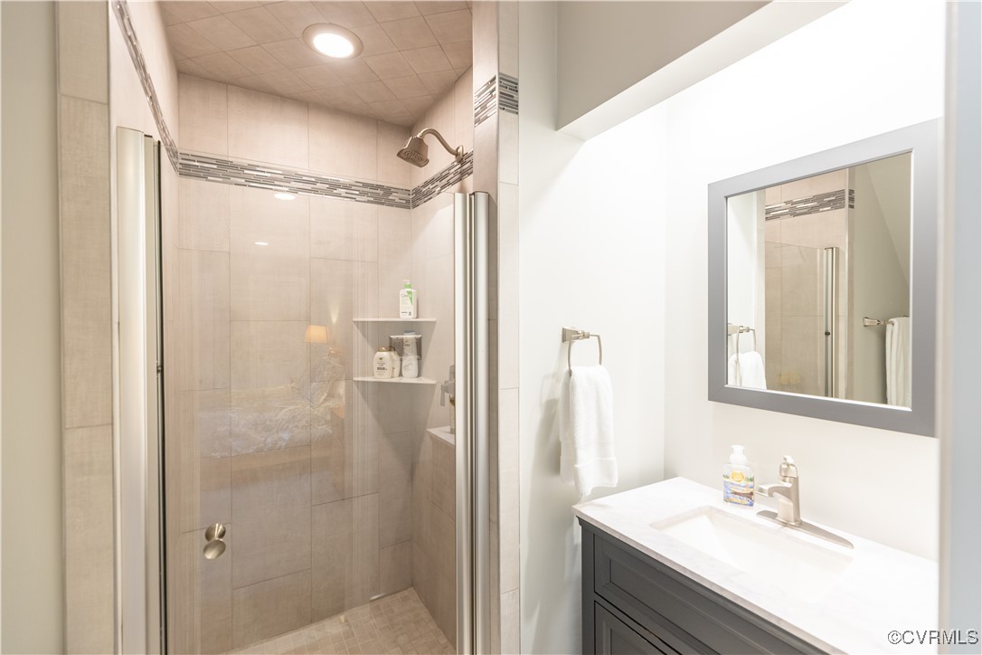 11319 Buckhead Terrace Midlothian, VA 23113 - Photo 27 of 35 a bathroom with a shower sink vanity and a mirror