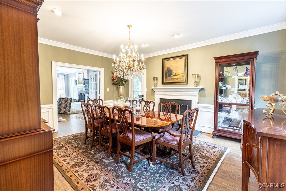 11319 Buckhead Terrace Midlothian, VA 23113 - Photo 10 of 35 a dining room with furniture a chandelier and wooden floor