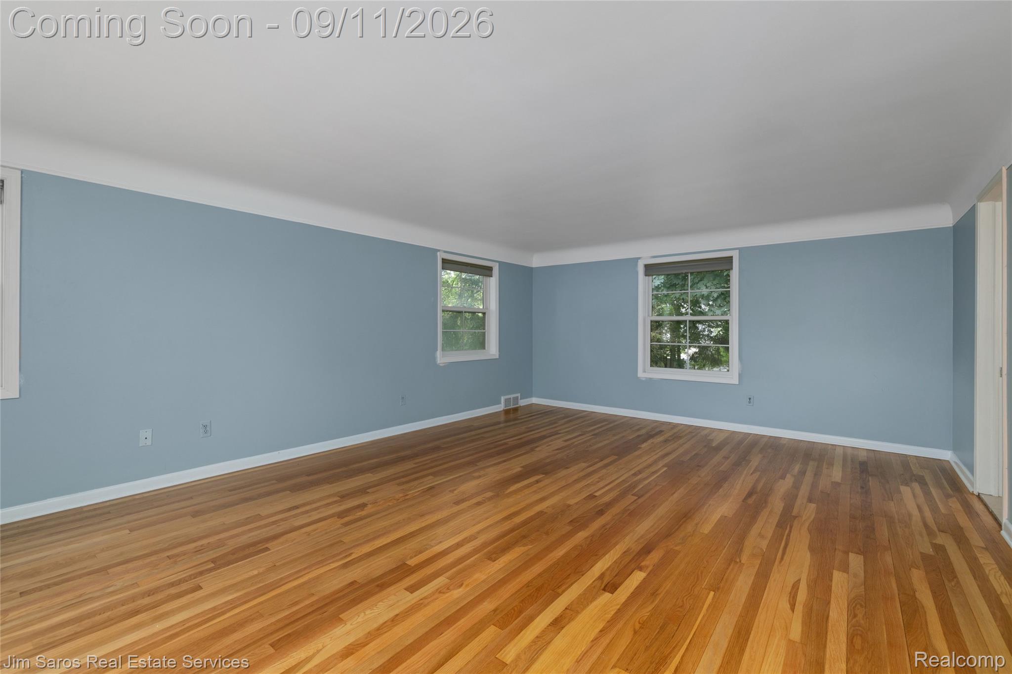 1445 Devonshire Road Grosse Pointe, MI 48230 - Photo 17 of 30 Hardwood flooring, painted walls, white trim, and multiple windows