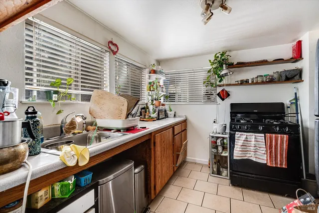 a kitchen with a sink stove and cabinets