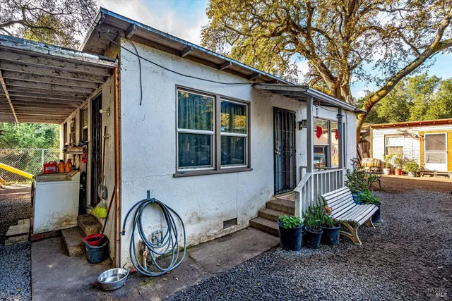 a view of house with backyard and outdoor seating