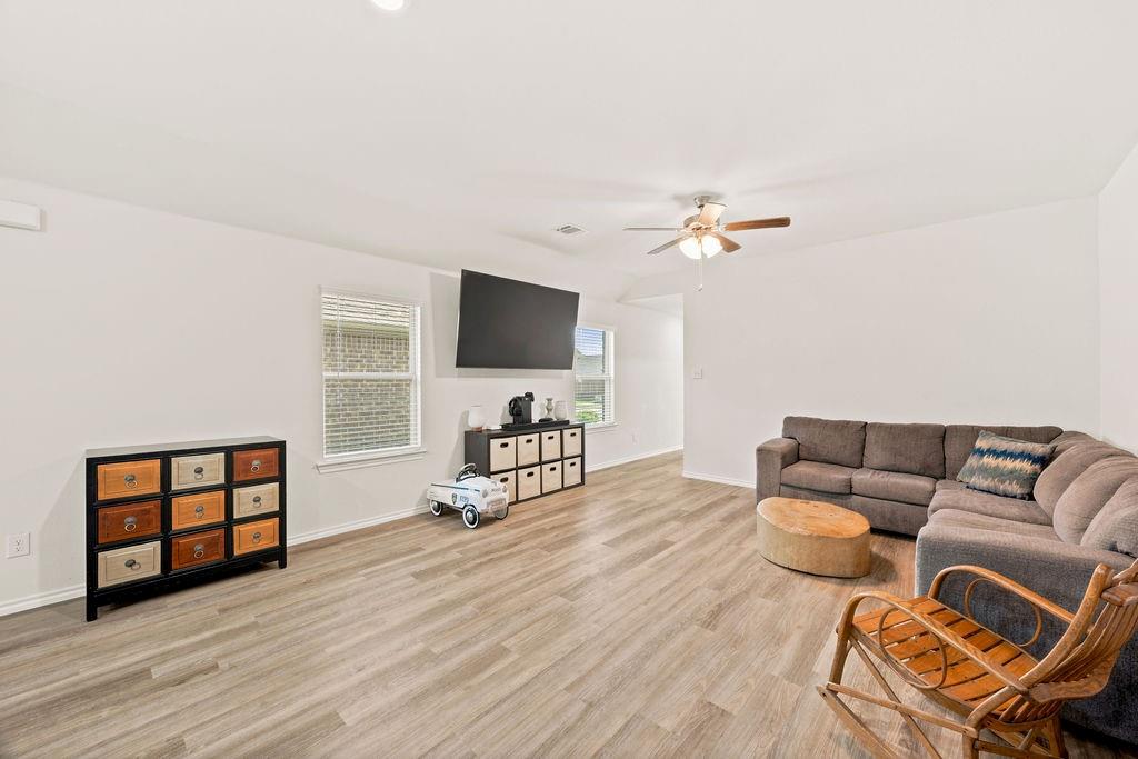 822 Ramble Road Lavon, TX 75166 - Photo 15 of 35 Spacious living area featuring light wood-finish flooring, recessed lighting, and a ceiling fan