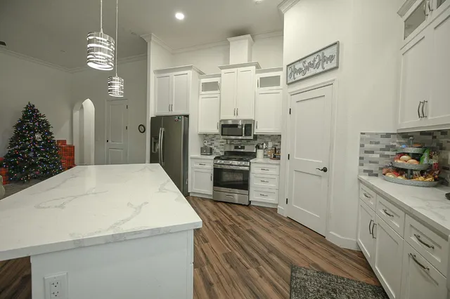 a kitchen with stainless steel appliances a refrigerator sink and stove