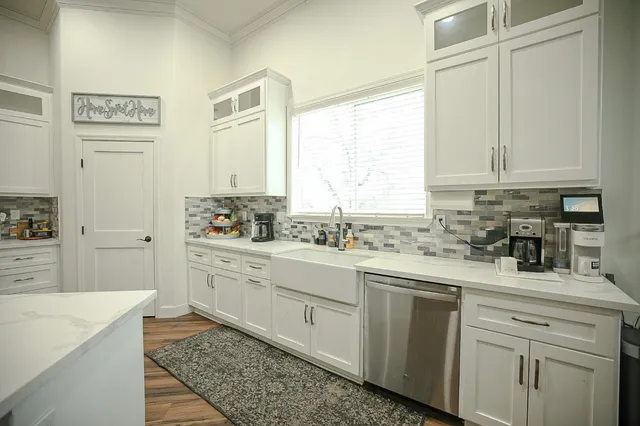 a kitchen with stainless steel appliances white cabinets and sink