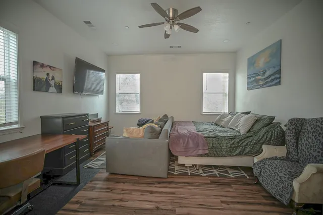 a living room with furniture and a wooden floor