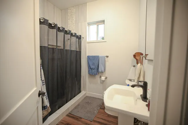 a bathroom with a sink a mirror and shower