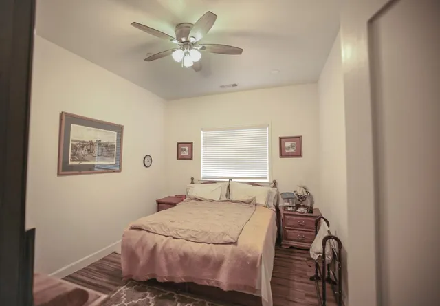 a bedroom with a bed and a chandelier