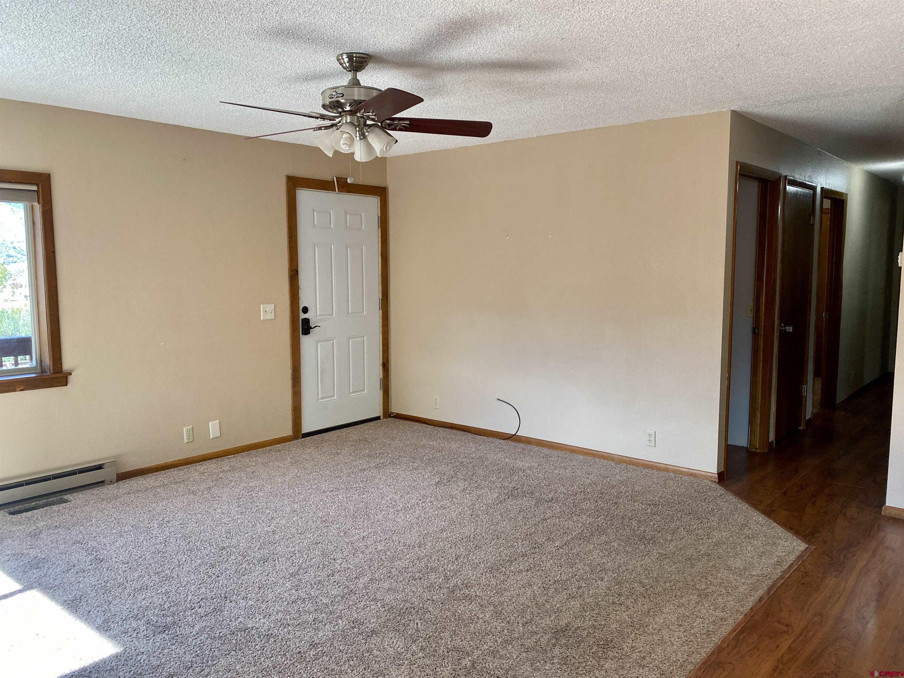 21430 Highway 550 Ridgway, CO 81432 - Photo 12 of 35 an empty room with closet and a chandelier fan