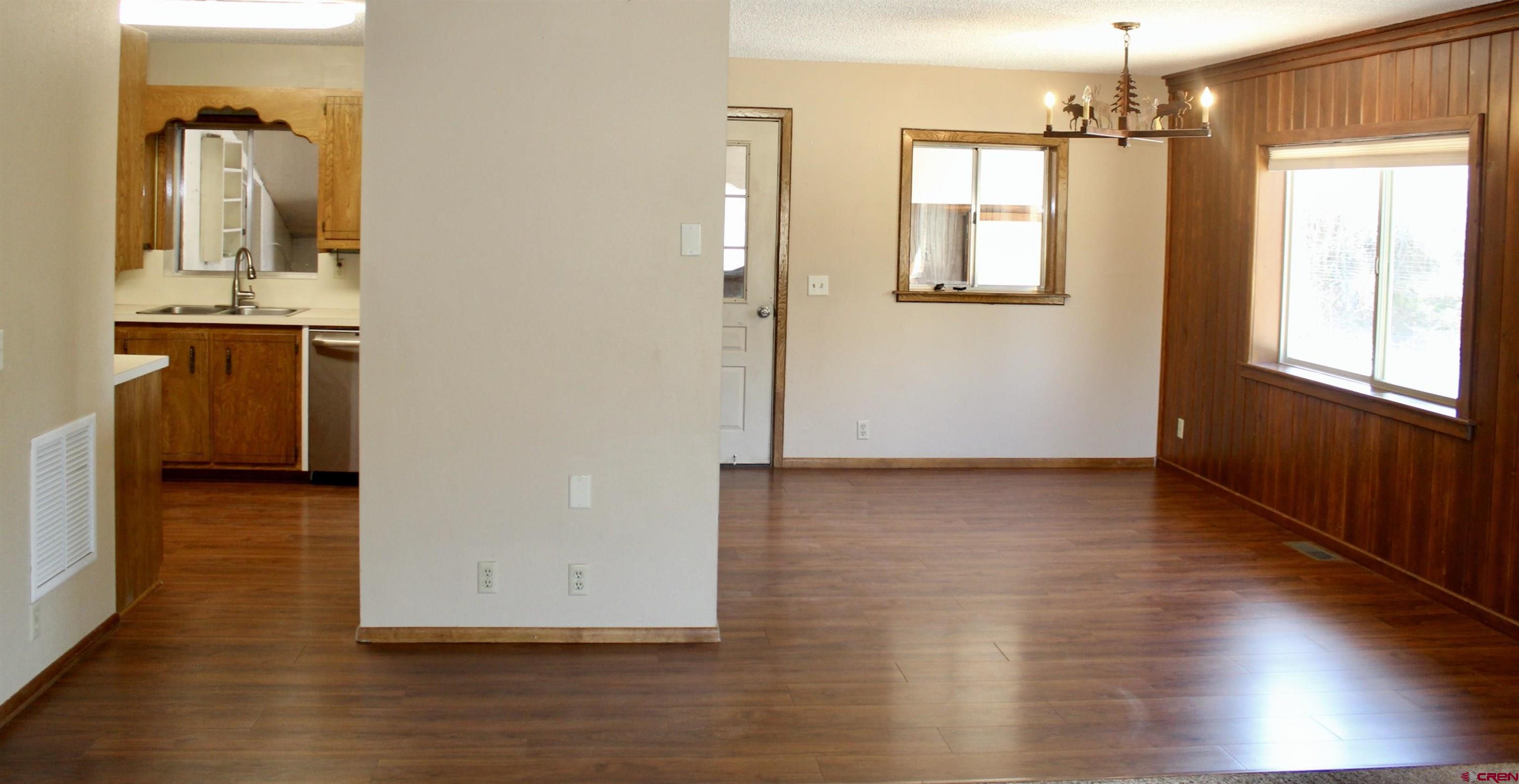 21430 Highway 550 Ridgway, CO 81432 - Photo 13 of 35 a view of a hallway with wooden floor and a living room