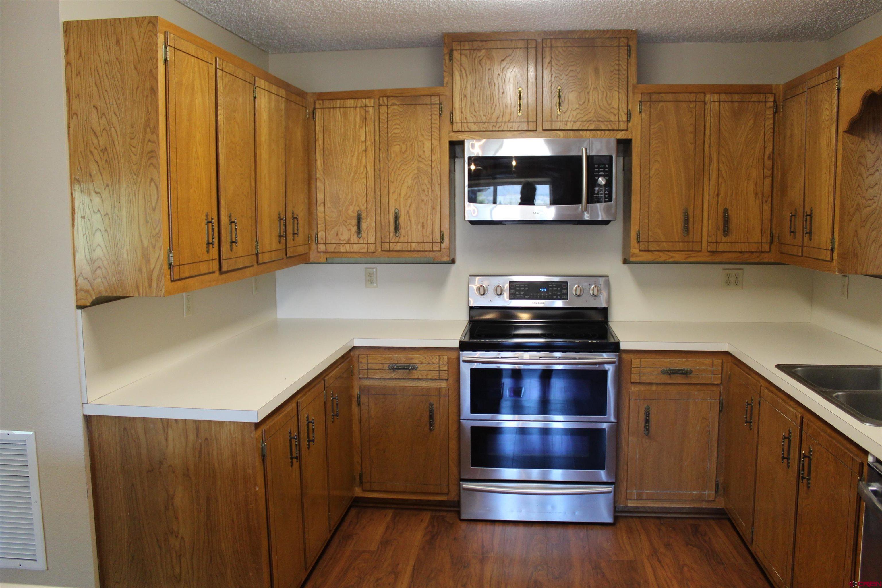 21430 Highway 550 Ridgway, CO 81432 - Photo 14 of 35 a kitchen with a stove and a microwave