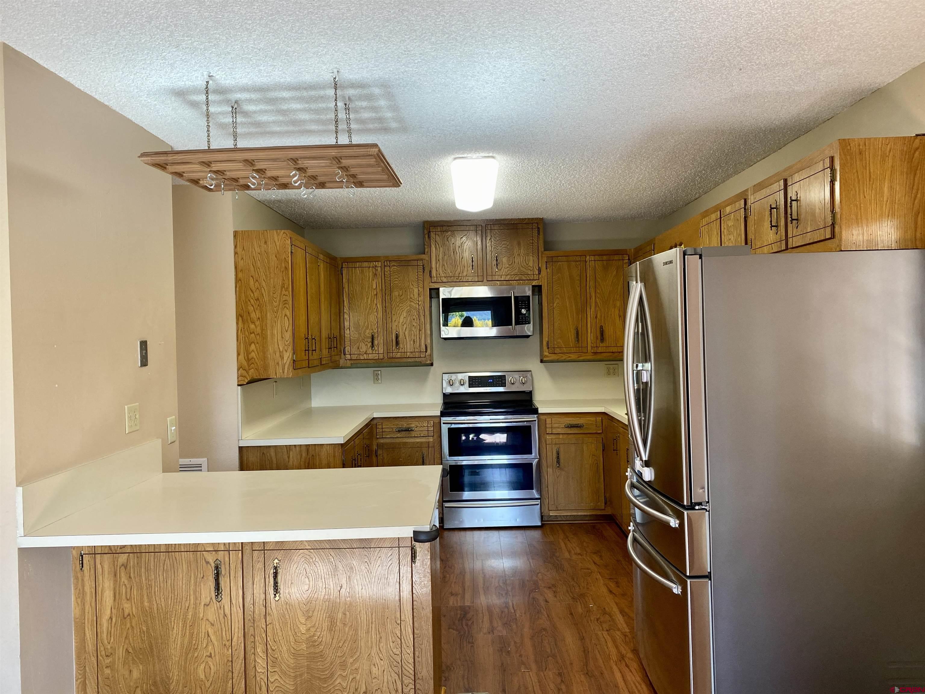 21430 Highway 550 Ridgway, CO 81432 - Photo 15 of 35 a kitchen with stainless steel appliances granite countertop a refrigerator and a stove
