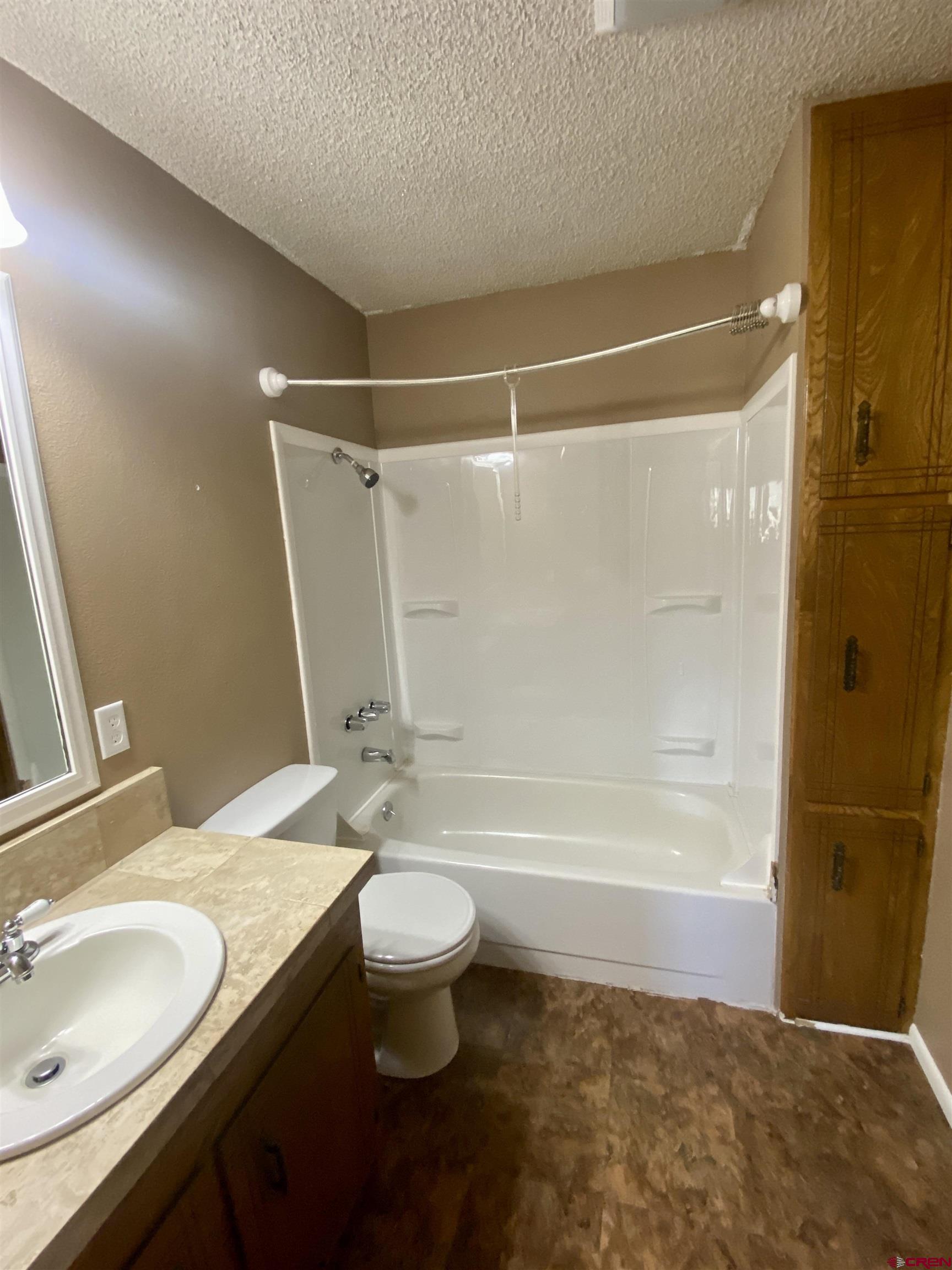 21430 Highway 550 Ridgway, CO 81432 - Photo 17 of 35 a bathroom with a granite countertop sink toilet and shower