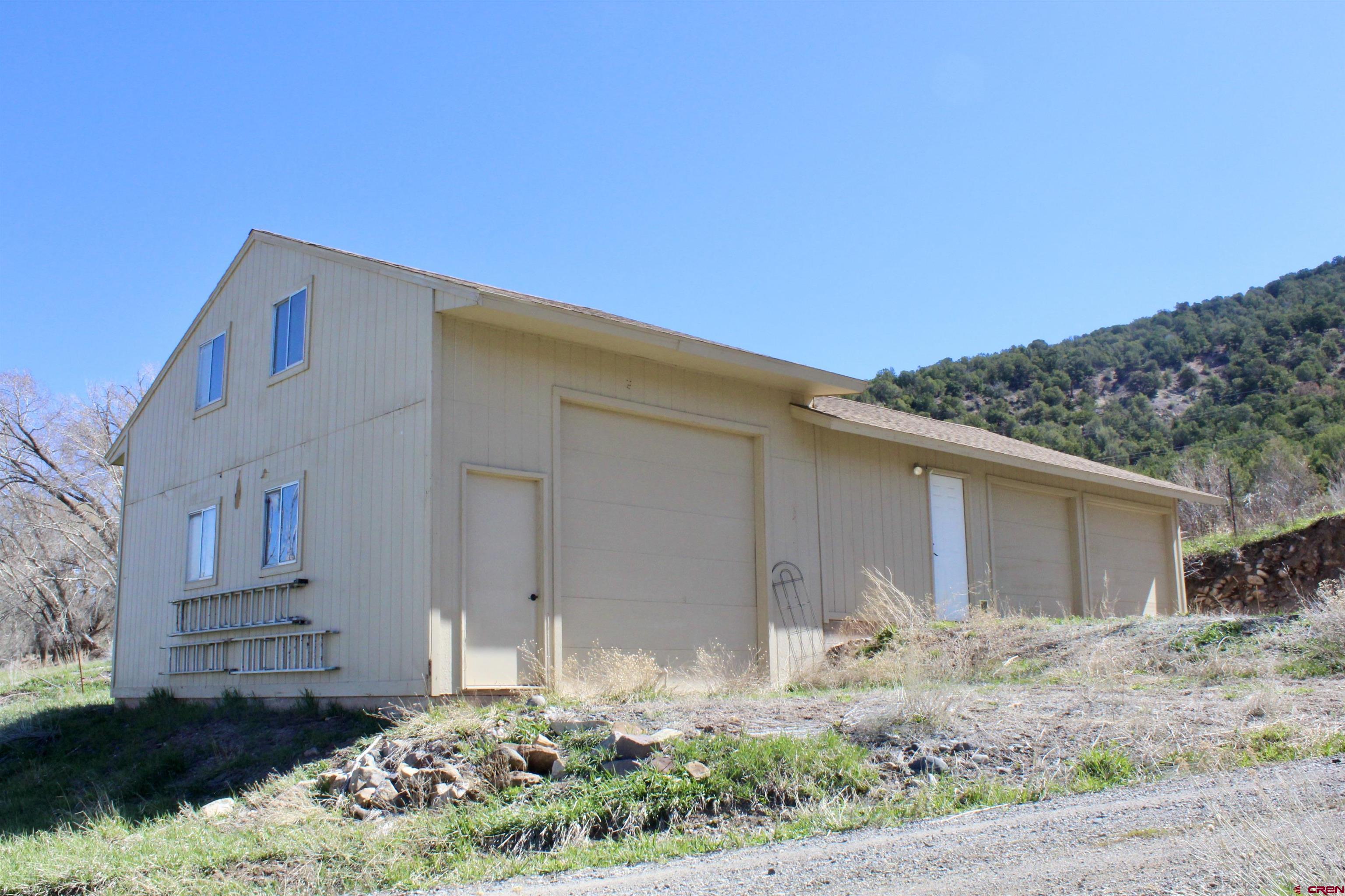 21430 Highway 550 Ridgway, CO 81432 - Photo 30 of 35 a front view of a house with garden