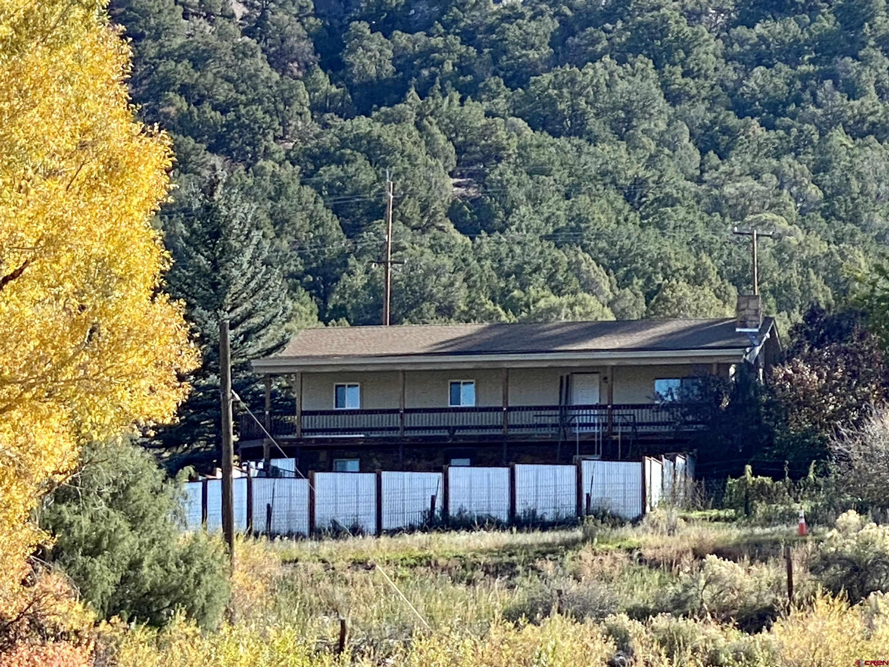 21430 Highway 550 Ridgway, CO 81432 - Photo 5 of 35 a front view of a house with a yard