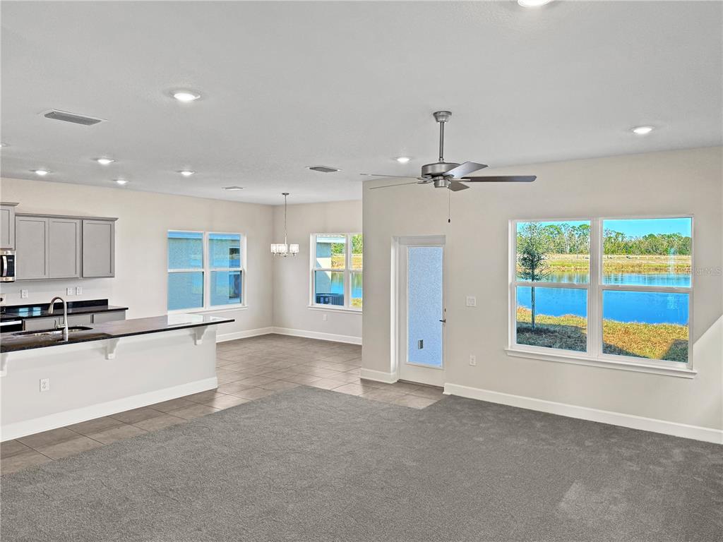 7545 Bent Tree Loop St. Cloud, FL 34773 - Photo 3 of 11 a large kitchen with stainless steel appliances granite countertop a refrigerator and a stove top oven