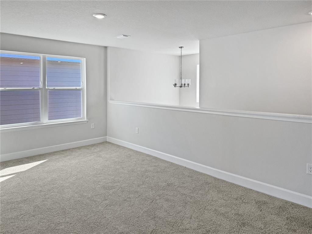 7545 Bent Tree Loop St. Cloud, FL 34773 - Photo 6 of 11 an empty room with windows