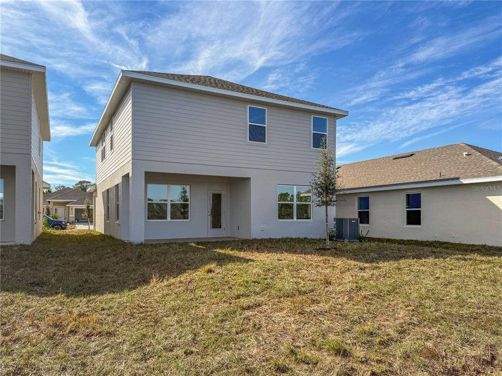 7545 Bent Tree Loop St. Cloud, FL 34773 - Photo 7 of 11 a view of a house with a yard