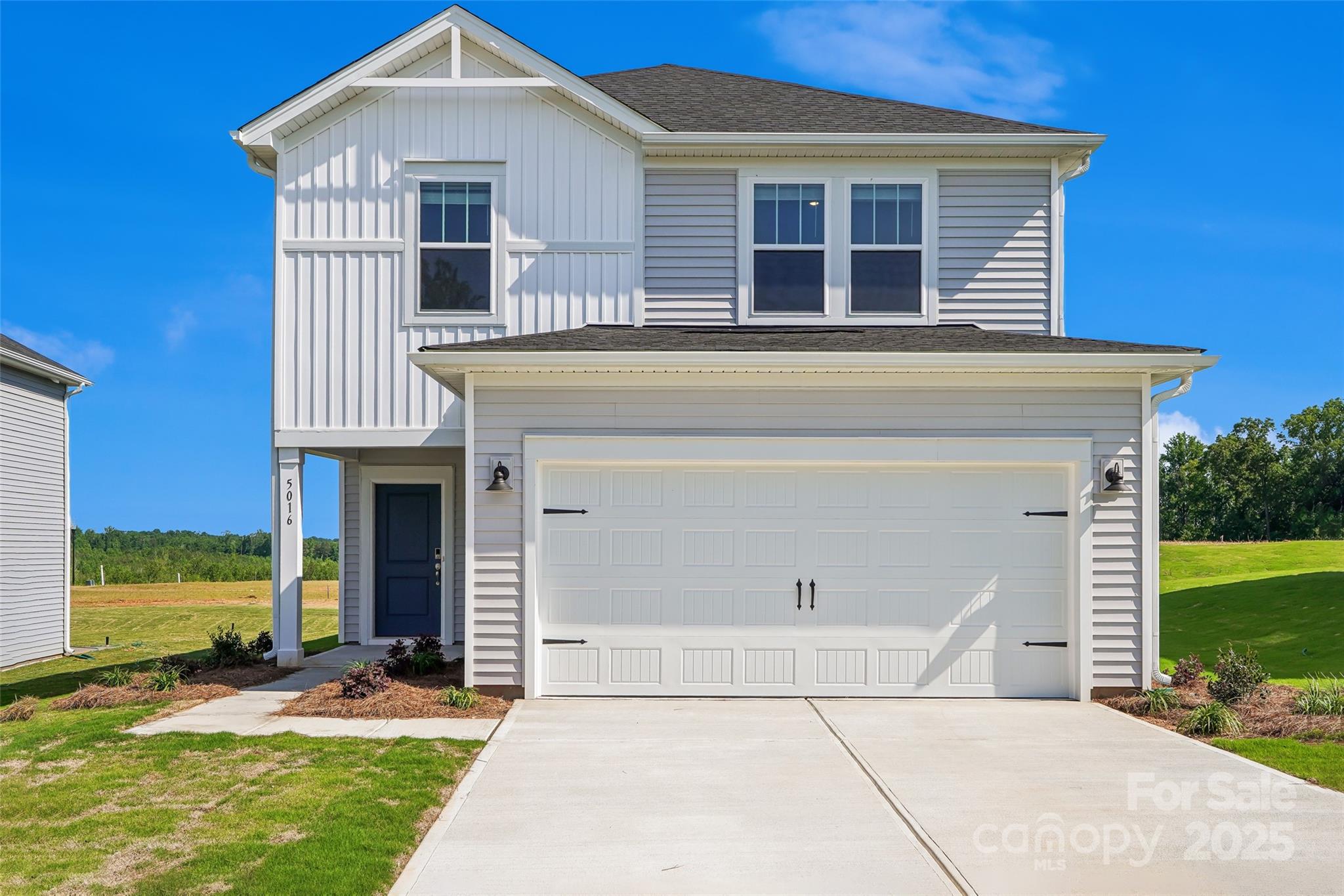 1305 30th St Lane Northeast Conover, NC 28613 - Photo 1 of 25 a front view of a house with a yard and garage