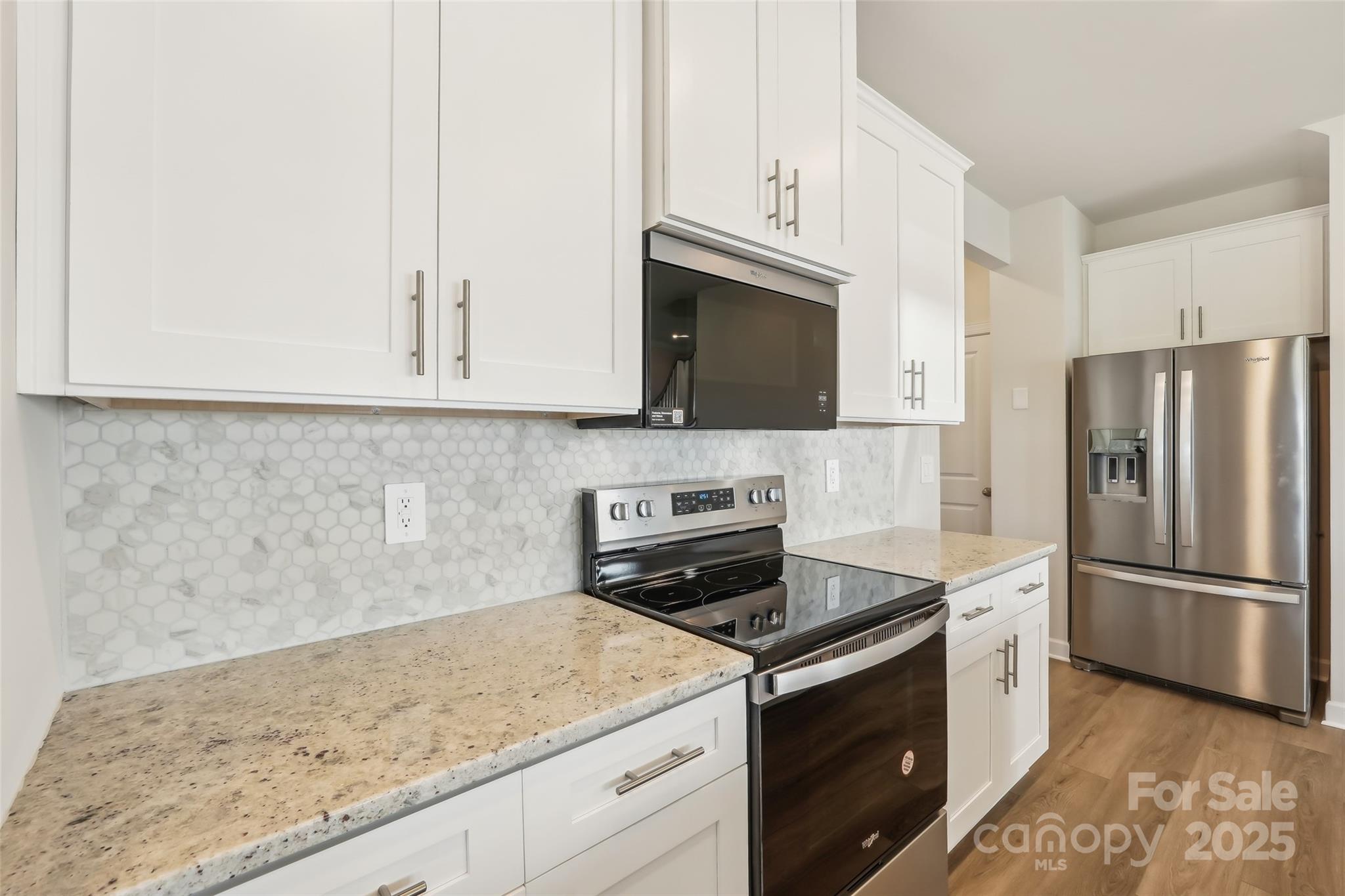 1305 30th St Lane Northeast Conover, NC 28613 - Photo 9 of 25 a kitchen with granite countertop white cabinets and stainless steel appliances