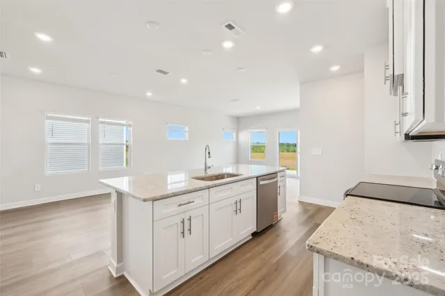 a kitchen with a sink stove and cabinets