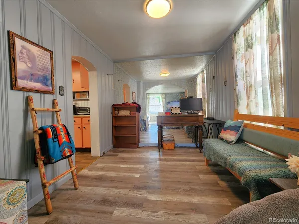 a living room with furniture a fireplace and a large window
