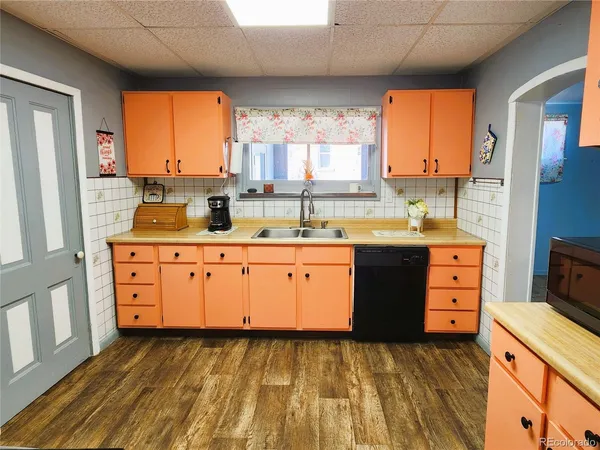 a kitchen with a sink stove and cabinets