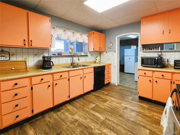 a kitchen with stainless steel appliances kitchen island granite countertop a sink window and cabinets
