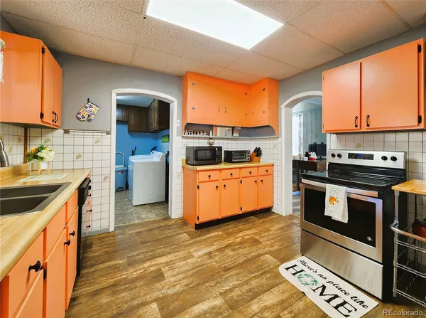 a kitchen with stainless steel appliances a stove sink and cabinets