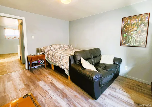 a living room with furniture and a lamp