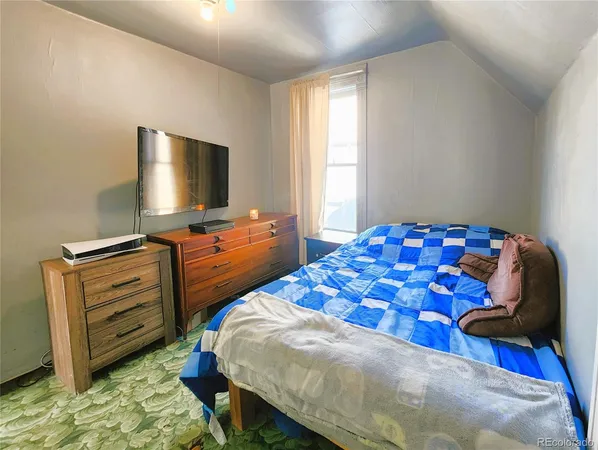 a bedroom with a bed and flat screen tv