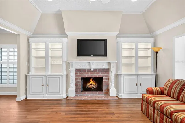 a living room with furniture fireplace and flat screen tv