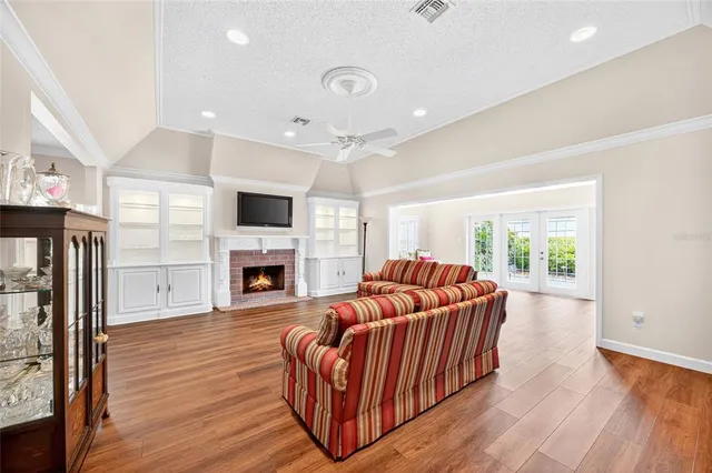 a living room with furniture a fireplace and a flat screen tv
