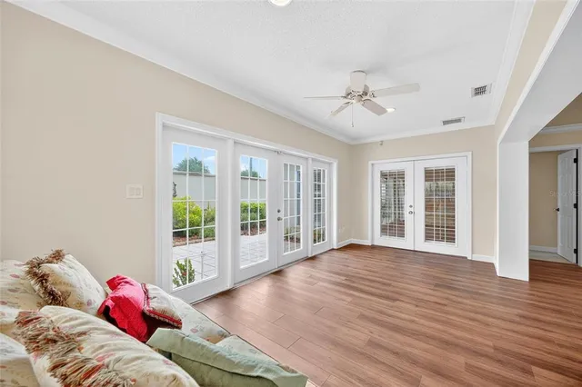 a living room with furniture and wooden floor